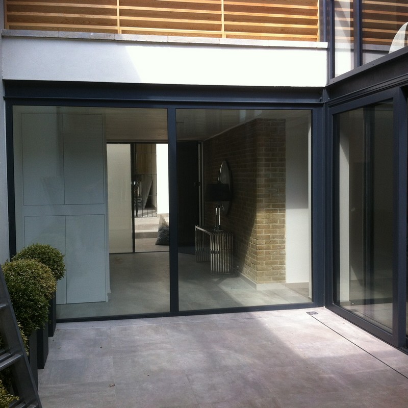 Floor-to-ceiling sliding doors opening to courtyard in Uxbridge